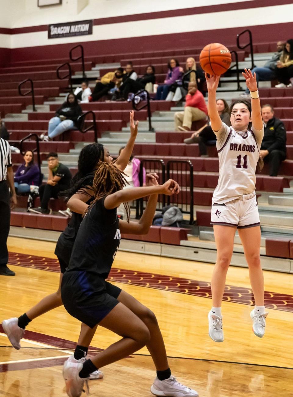 Katie Peiffer takes a three-point shot for Round Rock. Round Rock won a girls district basketball game 38-36 at home over Cedar Ridge on January 16th, 2024.