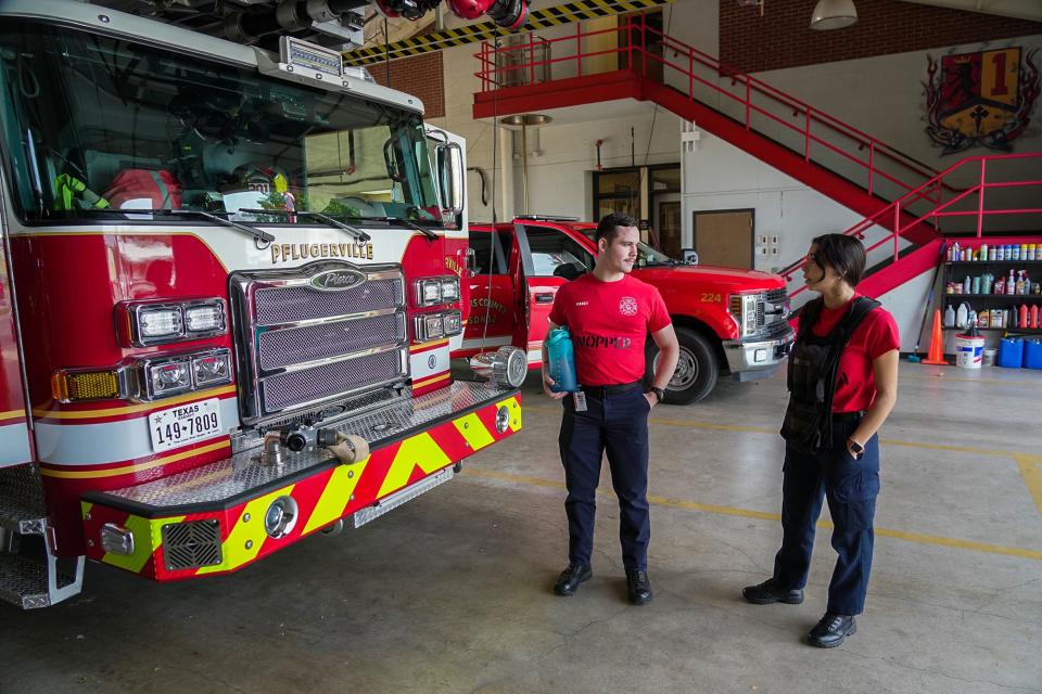 Pflugerville firefighter cadets Nicholas Nopper and Kaitlyn Mancia talk after a workout at Station 1. Mancia is an academy graduate and is in the current cadet class for ESD No. 2.