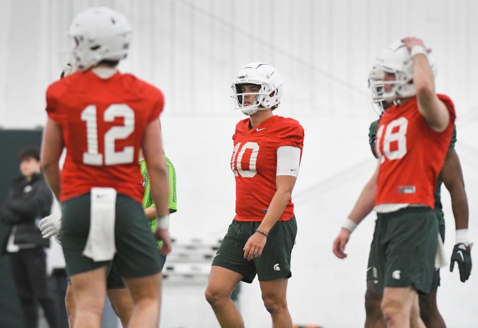 MSU quarterbacks Katin Houser, left, Payton Thorne, (10), and Andrew Schorfhaar pictured Tuesday, March 14, 2023, during the first day of spring practice at the indoor football facilty in East Lansing.