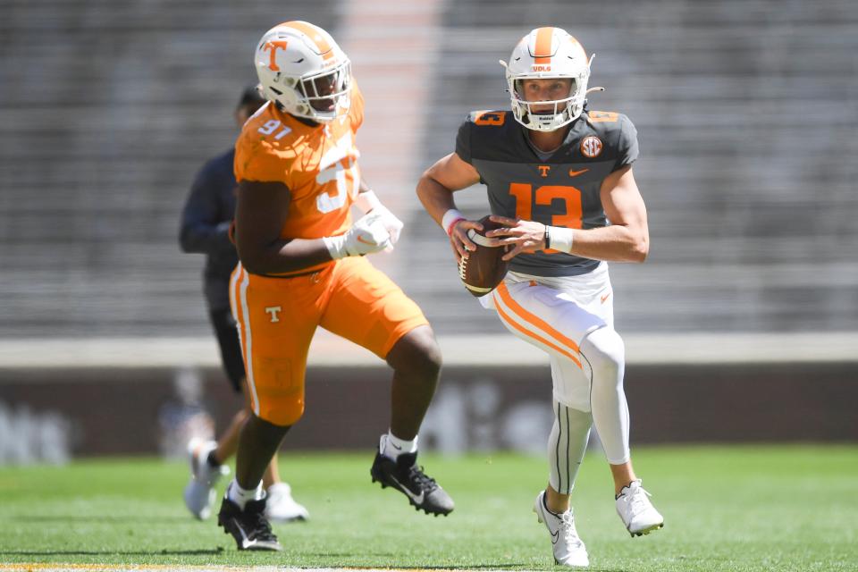 Tennessee quarterback Gaston Moore (13) is pressured by defensive lineman Jayson Jenkins (97) during the Orange & White spring game, in Neyland Stadium, Saturday, April 15, 2023.