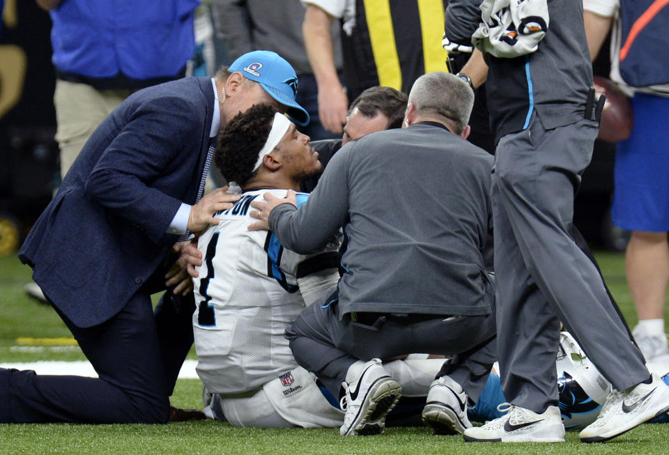 Carolina Panthers quarterback Cam Newton is tended to by medical personnel after being sacked in the second half of an NFL football game against the New Orleans Saints in New Orleans, Sunday, Jan. 7, 2018. (AP Photo/Bill Feig)