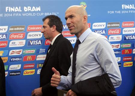 Former France soccer player Zinedine Zidane (R) arrives for the draw for the 2014 World Cup at the Costa do Sauipe resort in Sao Joao da Mata, Bahia state, December 6, 2013. REUTERS/Ricardo Moraes