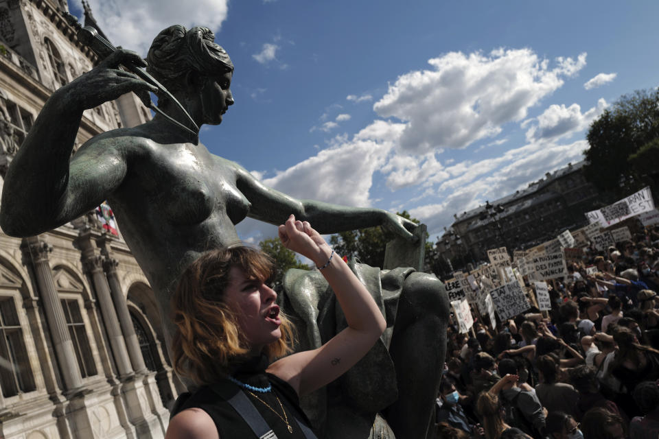 Women's rights activists protest against French President Emmanuel Macron's appointment of an interior minister who has been accused of rape and a justice minister who has criticized the #MeToo movement, in front of Paris city hall, in Paris, France, Friday, July 10, 2020. The French government said it remains committed to gender equality and defended the new ministers, stressing the presumption of innocence. Gerald Darmanin, Interior Minister, firmly denies the rape accusation, and an investigation is underway. New Justice Minister Eric Dupond-Moretti is a lawyer who has defended a government member accused of rape and sexual assault, and has ridiculed women speaking out thanks to the #MeToo movement. (AP Photo/Francois Mori)