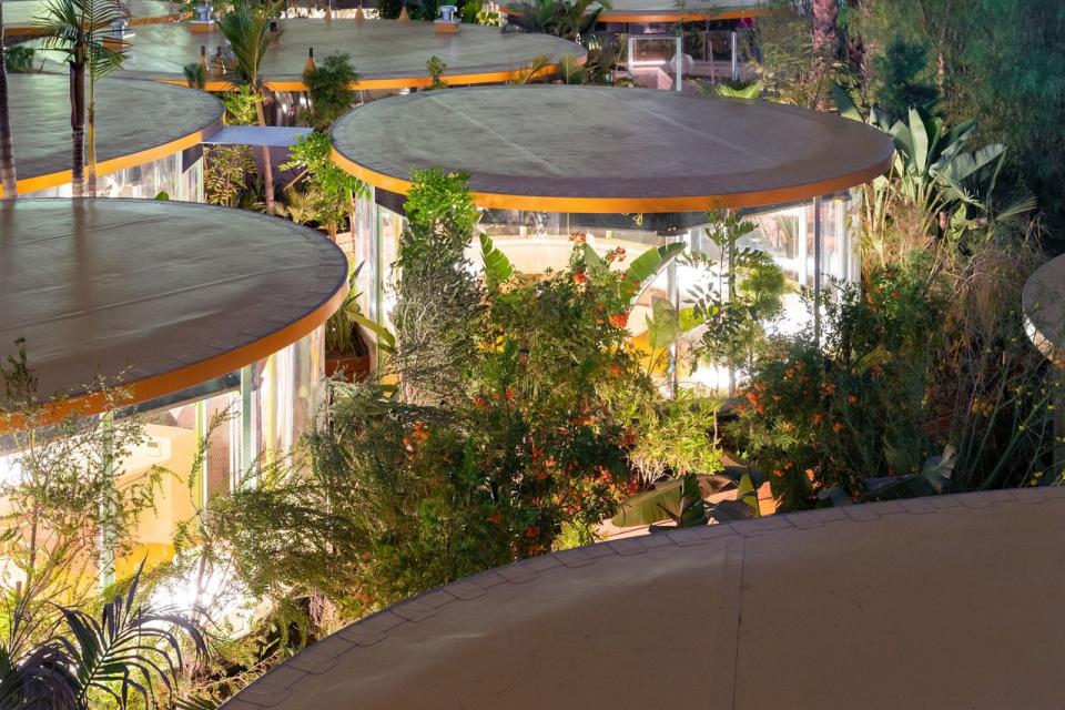 The outdoor pods that make up Selgacanso's Second Home Hollywood campus glow softly in the evening darkness.