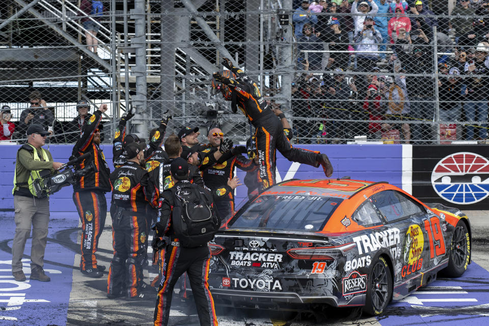 Martin Truex Jr., center, jumps from his car after winning the NASCAR 400 auto race at Dover Motor Speedway, Monday, May 1, 2023, in Dover, Del. (AP Photo/Jason Minto)
