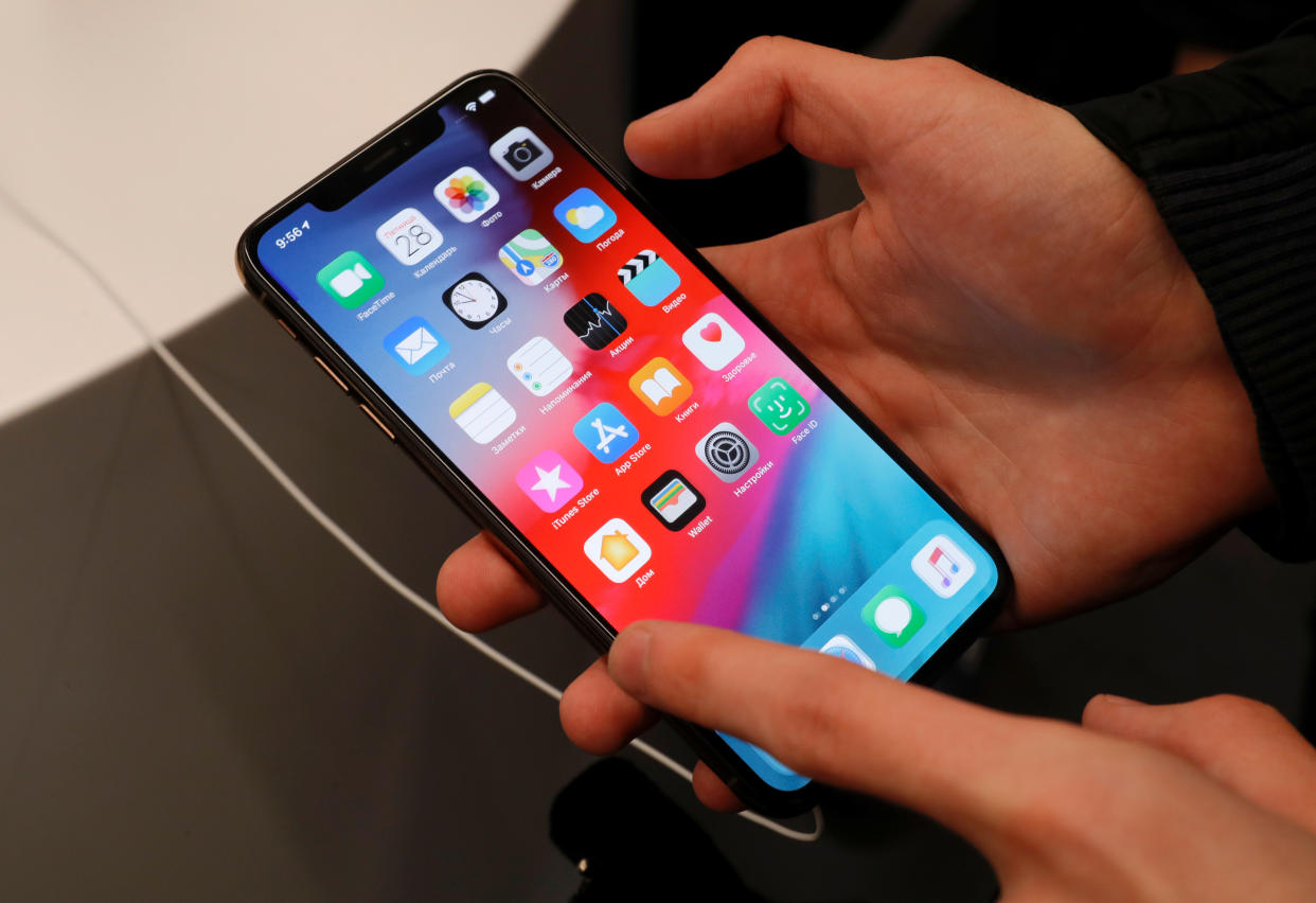 A customer tests a smartphone during the launch of the new iPhone XS and XS Max sales at 