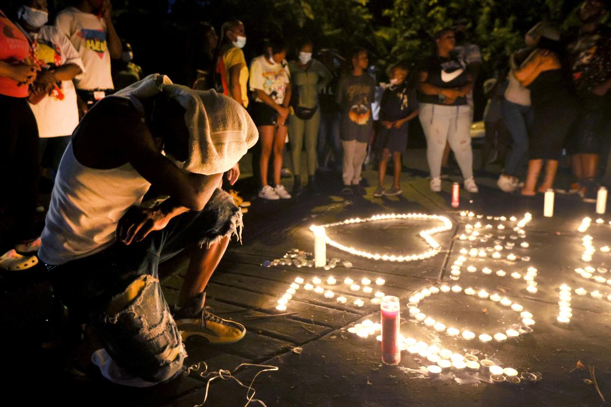 Family and friends gather to honor and mourn Antonio Jackson on the corner of Robin Hood Lane and Norris Avenue Tuesday, Aug. 17, 2021. Jackson died Monday afternoon after a sheriff's deputy fired shots into his car at the Robinhood Park Apartments.