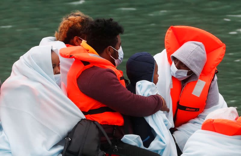 FILE PHOTO: Border Patrol agents bring migrants into Dover harbour on a boat, in Dover