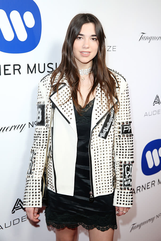 In a black mini slip dress and black-and-white jacket