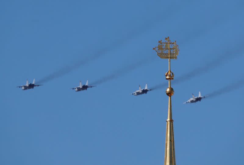 Russian military aircraft fly in formation during an air parade on Victory Day in Saint Petersburg