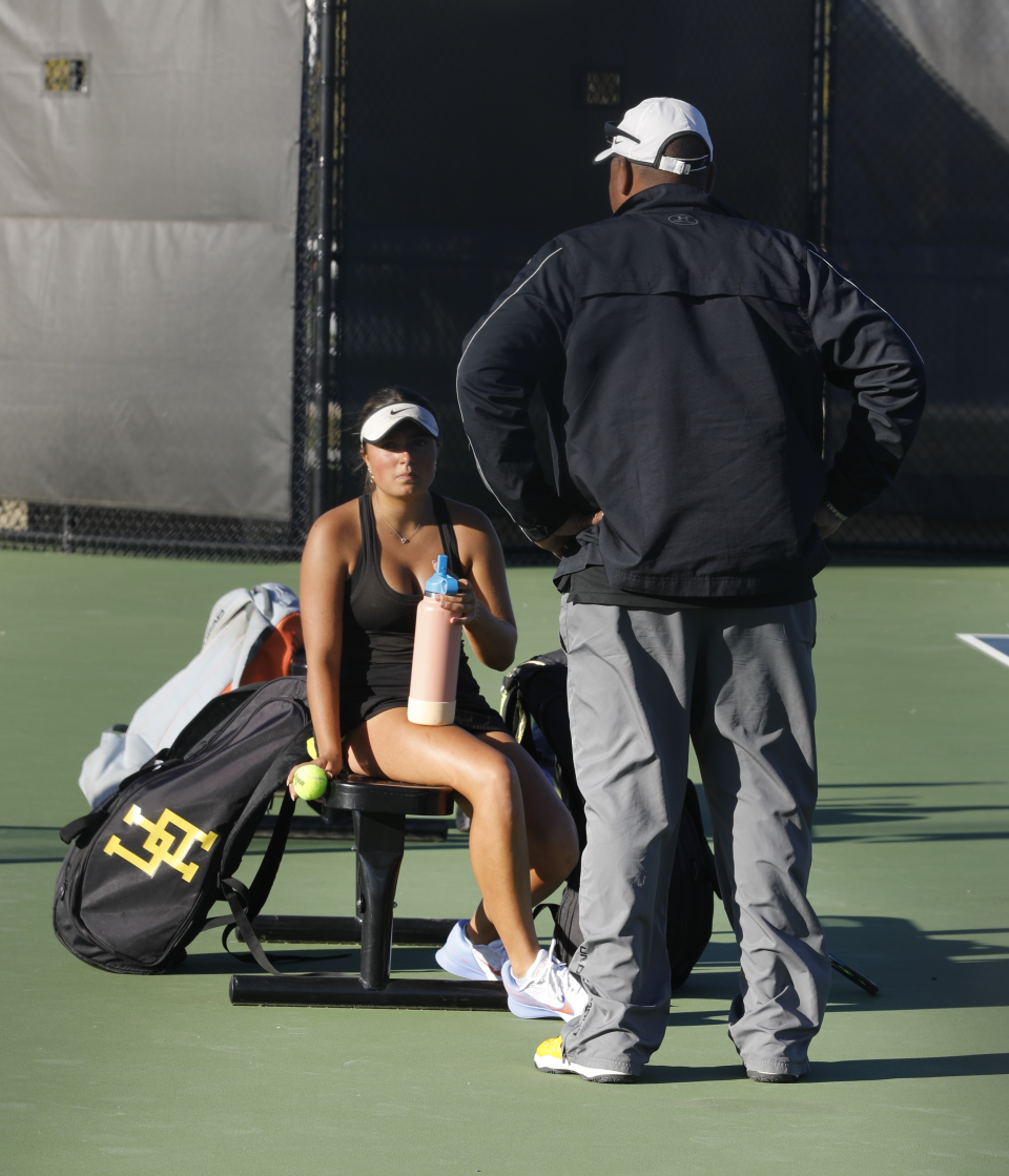 Upper Arlington's Alexa Roth listens to coach Shaun Stamps during a break in her first singles match against New Albany's Airi Clements in Wednesday's Ohio Tennis Coaches Association Division I district final.