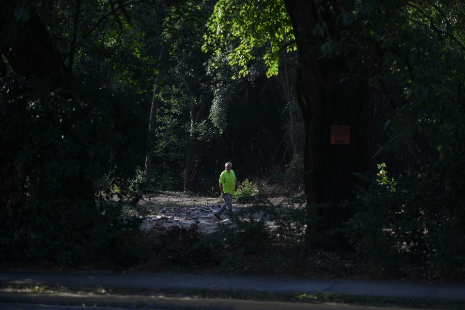 Workers with Fish Brothers House Movers survey the ground on McDowell Street after the historic Fordyce-Kennedy-Pritchard House was moved on Thursday, Sept. 7, 2023.