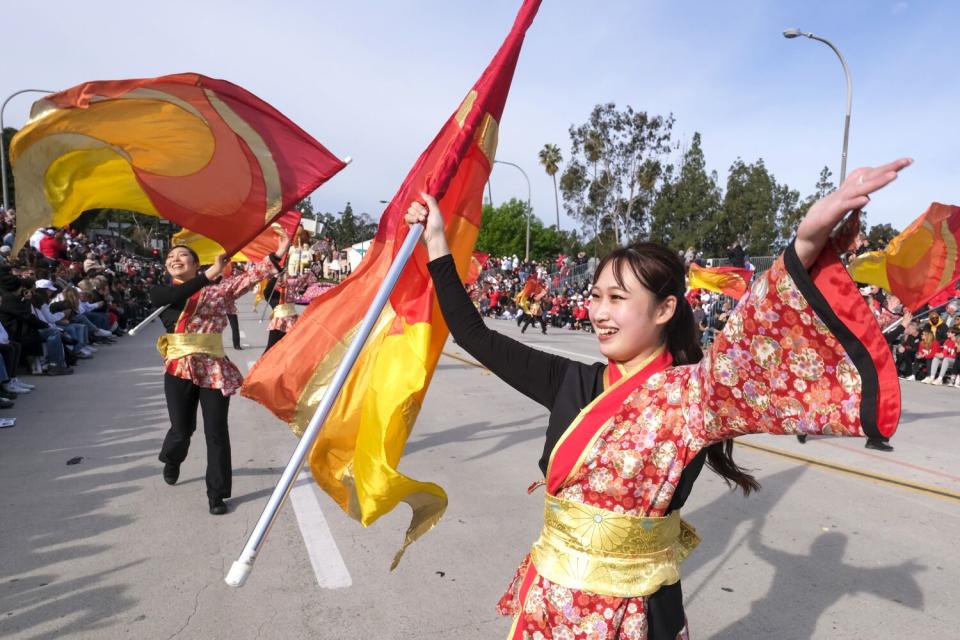 Dancers with flags at the Rose Parade.