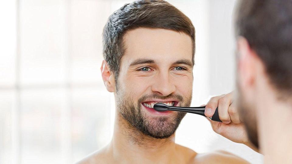 The AquaSonic Black Series electric toothbrush lets you clean your teeth in four different ways.