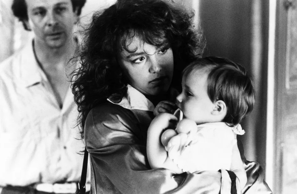 Roland Giraud, Philippine Leroy Beaulieu, and Jennifer Moret in a black-and-white scene from "Three Men and a Cradle"