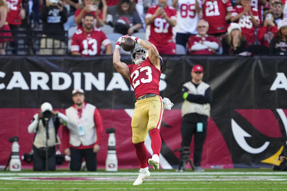 San Francisco 49ers running back Christian McCaffrey (23) catches a touchdown pass during the second half of an NFL football game against the Arizona Cardinals Sunday, Dec. 17, 2023, in Glendale, Ariz. (AP Photo/Matt York)