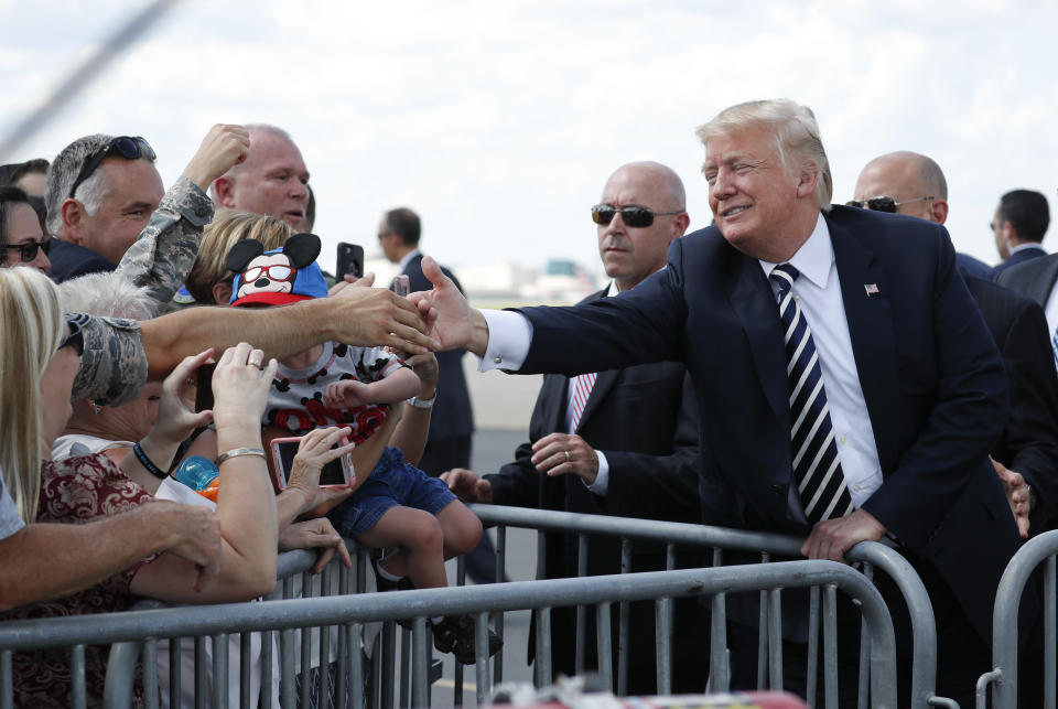 President Donald Trump greets guests on the tarmac upon his arrival on Air Force One at Charlotte Douglas International Airport, Friday, Aug. 31, 2018 in Charlotte, N.C. (AP Photo/Pablo Martinez Monsivais)