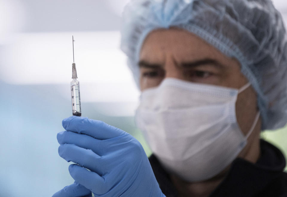 A technician prepares a Pfizer vaccine in the pharmacy area of the newly opened COVID-19 Vaccination Centre in Sydney, Australia, Monday, May 10, 2021. (James Gourley/Pool Photo via AP)