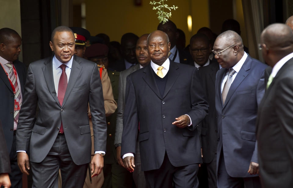 FILE - In this July 31, 2013, file photo, Kenya's President Uhuru Kenyatta, left, Uganda's President Yoweri Museveni, center, and the transitional leader of the Central African Republic Michel Djotodia, right, arrive for the Special Summit of the International Conference on the Great Lakes Region (ICGLR) held at the United Nations Office in Nairobi, Kenya. Uganda's President Museveni is expected to sign Monday, Feb. 24, 2014 a controversial anti-gay bill that allows harsh penalties for homosexual offenses, a bill which rights groups have condemned as draconian in a country where homosexuality is already illegal. (AP Photo/Ben Curtis, File)