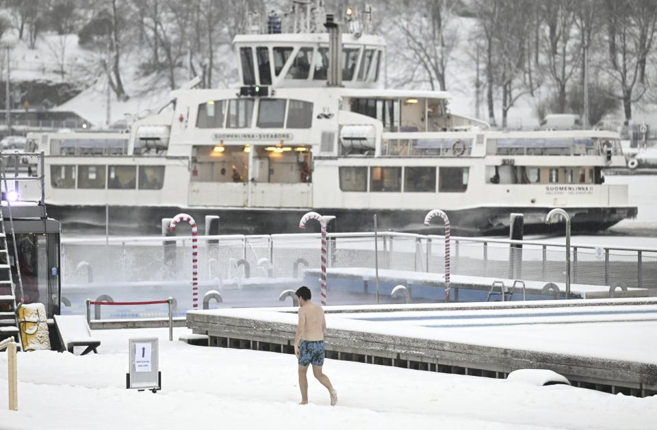 A man walks by the Allas Sea Pool, in Southern Helsinki, Finland, Tuesday, Jan. 2, 2024. Finland and Sweden have recorded this winter’s cold records on Tuesday as a temperatures plummeted to over minus 40 degrees as a result of a cold spell prevailing in the Nordic region. (Vesa Moilanen/Lehtikuva via AP)