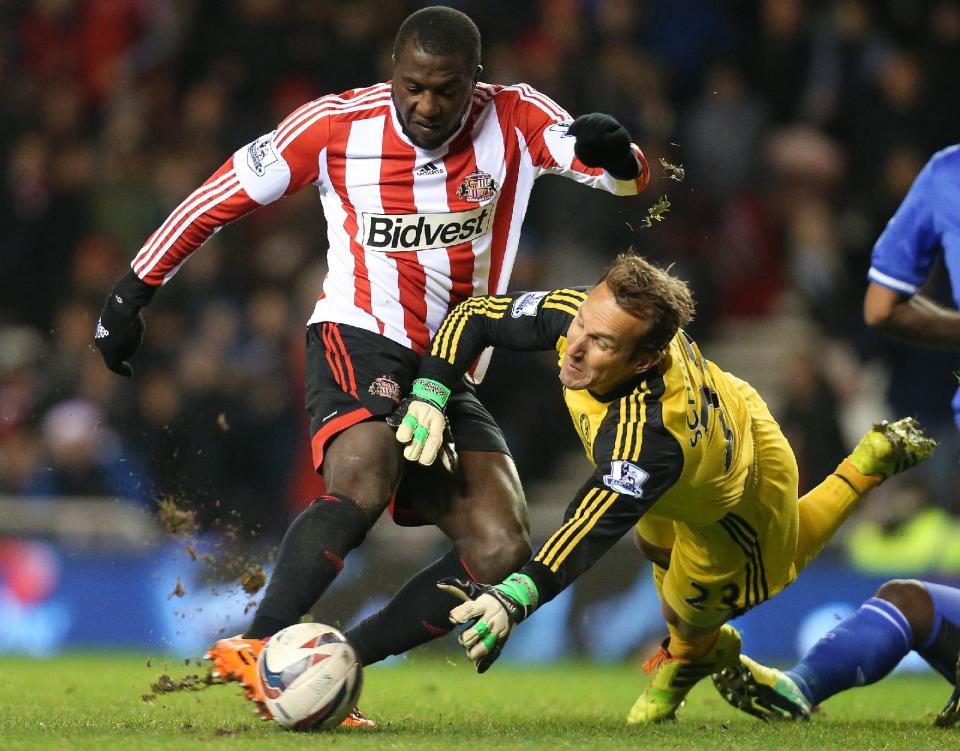 Sunderland's Jozy Altidore, left, hits a shot toward goal past Chelsea's goalkeeper Mark Schwarzer, right, during an English League Cup quarterfinal soccer match in Sunderland, England. Altidore's disappointing first season with Sunderland has less than a month remaining, and it appears as though the American's struggles for playing time aren't finished. Altidore, who scored 31 goals in 41 games for AZ Alkmaar in the Dutch league last year, was an unused substitute for last-place Sunderland in a 2-2 tie with Manchester City on Wednesday, April 16. (AP Photo/Scott Heppell, File)