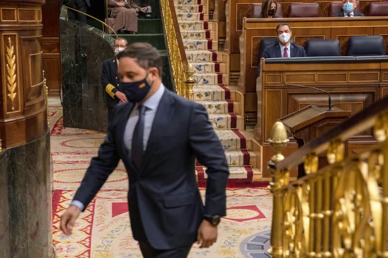 Santiago Abascal, leader of far-right party Vox, walks to give his speech as Spain Prime Minister Pedro Sanchez looks on during a no confidence motion against the government at parliament in Madrid