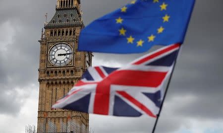 The Union Flag and a European Union flag fly near the Elizabeth Tower, housing the Big Ben bell, during the anti-Brexit 'People's March for Europe', in Parliament Square in central London, Britain September 9, 2017. REUTERS/Tolga Akmen/Files