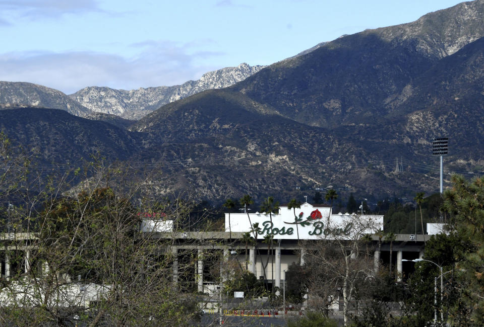 The Rose Bowl with the San Gabriel Mountains as a rain storm is expected in Pasadena, Calif., on Wednesday, Jan. 27, 2021. Wide areas of the state remained under warnings and watches for flooding, heavy snow and winds. (Keith Birmingham/The Orange County Register/SCNG via AP)