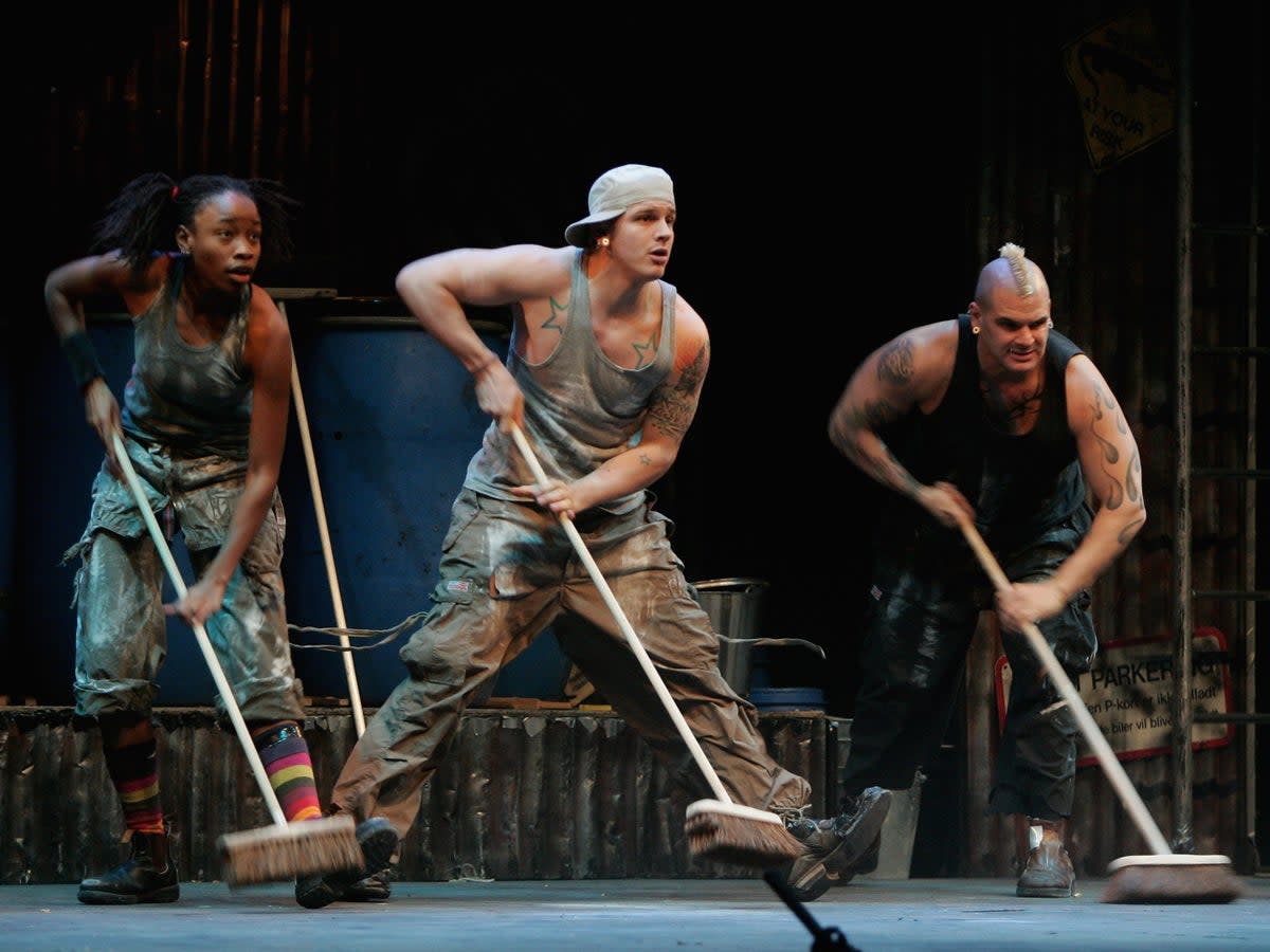 Performers using brooms as percussive instruments during a performance of ‘Stomp’ in Berlin, Germany (Getty Images)