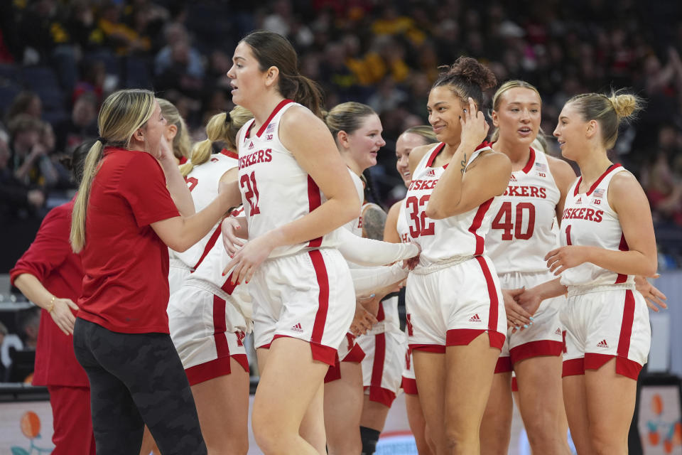 Nebraska guard Kendall Coley (32) celebrates with teammates after making a 3-point basket to end the first quarter during an NCAA college basketball game against Maryland in the semifinals of the Big Ten women's tournament, Saturday, March 9, 2024, in Minneapolis. (AP Photo/Abbie Parr)