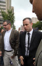 Oscar Pistorius accompanied by relatives arrives at the high court in Pretoria, South Africa, Monday, April 14, 2014. Pistorius is charged with murder for the shooting death of his girlfriend, Reeva Steenkamp, on Valentines Day in 2013. (AP Photo/Themba Hadebe)