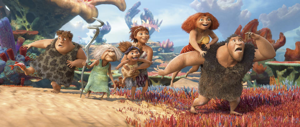 This film publicity image released by DreamWorks Animation shows, from left, Thunk, voiced by Clark Duke, Gran, voiced by Cloris Leachman, Ugga, voiced by Catherine Keener, who is holding Sandy, voiced by Randy Thom, Eep, voiced by Emma Stone and Grug, voiced by Nicolas Cage, in a scene from "The Croods." (AP Photo/DreamWorks Animation)