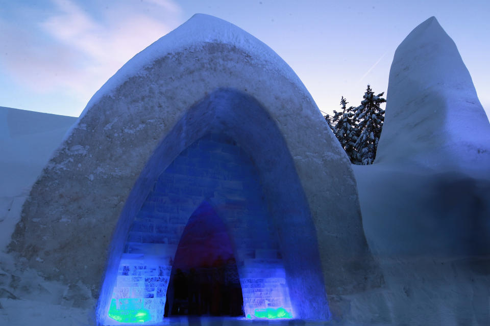 Visitors stand inside a church made entirely of snow and ice in southern Bavaria on January 14, 2012 in Mitterfirmiansreut, Germany. Local enthusiasts built the church at the end of December in an effort to relive a tradition dating back over 100 years. In 1910 the residents of Mitterfirminsreut were cut off from their local parish by a heavy snowstorm, and since the village was without its own church, they were unable to attend Christmas mass. Then in January of 1911, in an act meant in protest against local authorities whom they felt had forgotten them, the residents built their own church out of the material they had most in abundance at the time: snow. This year the snow church, backed by a local association, is scheduled to stand through February and has quickly become a local tourist attraction.  (Photo by Johannes Simon/Getty Images)