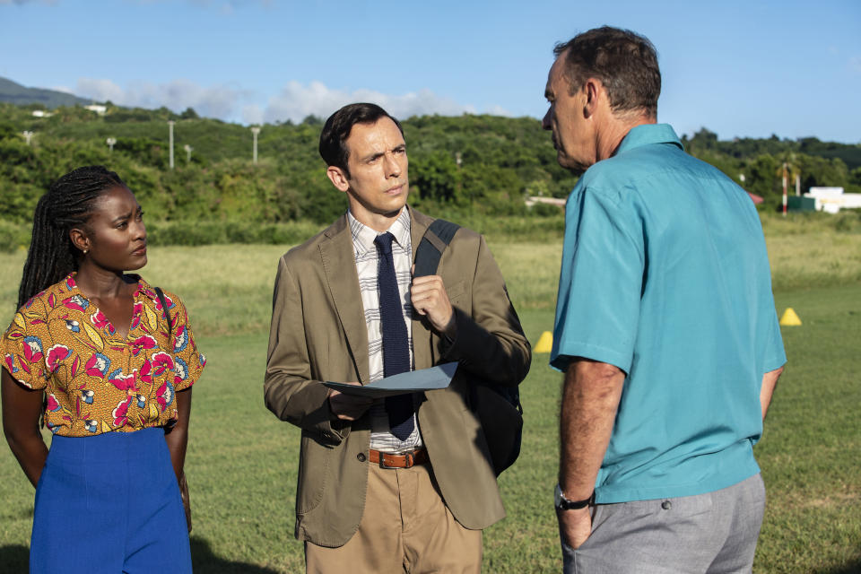 On the airfield, Naomi (Shantol Jackson) and Neville (Ralf Little) interview Peter Holcroft (Richard Lintern)