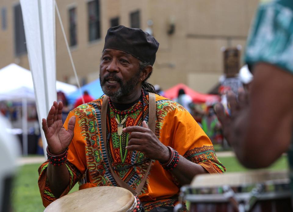 Kwame Williams, a member of Percussion Discussion Akron, performs at the 2016 Akron African American Cultural Festival at Lock 3.