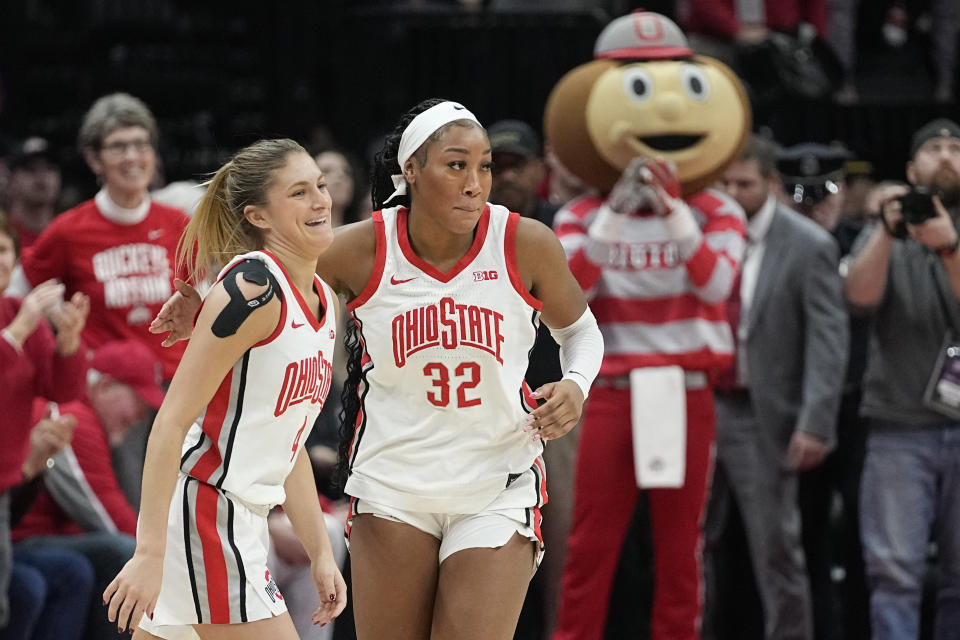 Ohio State's Cotie McMahon, right, and Jace Sheldon, left, celebrate near the end of overtime as Ohio State defeats Iowa in an NCAA college basketball game Sunday, Jan. 21, 2024, in Columbus, Ohio. (AP Photo/Sue Ogrocki)