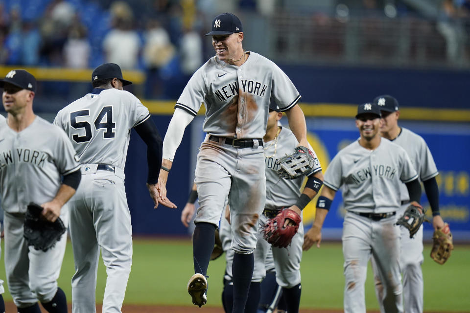 New York Yankees' Aaron Judge, center, celebrates with relief pitcher Aroldis Chapman, second from left, after the team defeated the Tampa Bay Rays during a baseball game Wednesday, July 28, 2021, in St. Petersburg, Fla. (AP Photo/Chris O'Meara)