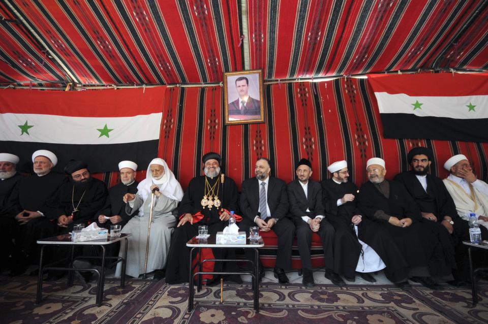 Muslim and Christian clerics gather inside a tent to express their solidarity with Syria's President Bashar al-Assad near a polling station in al-Othman mosque in Damascus June 3, 2014. (REUTERS/Omar Sanadiki)