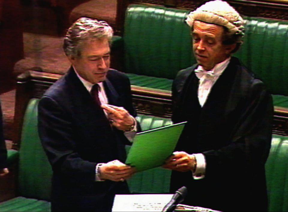 Maverick British MP Tony Banks seen here in this television image taken Tuesday May 13, 1997, crosses his fingers during swearing in ceremonies of the new government in the House of Commons at Westminster. The boisterous Banks later denied he was mocking the crown, and his behaviour has drawn outrage from Conservative politicians who say the oath of allegiance should be taken very seriously by any MP. Mr. Banks gained a reputation as a joker who poked fun at Commons tradition. He is now the new SportsMinister.(AP Photo)