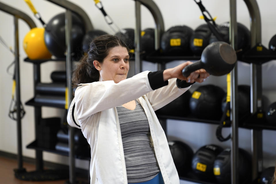 Rep. Haley Stevens, D-Mich., excercises at Burn Fitness in Rochester Hills, Mich., Monday, June 21, 2021. Michigan is fully open again. After facing 15 months of capacity restrictions and being hit by the country’s worst surge of coronavirus infections this spring, restaurants, entertainment businesses and other venues can operate at 100% occupancy starting Tuesday. (AP Photo/Paul Sancya)