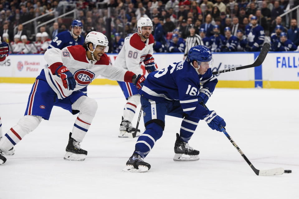 Toronto Maple Leafs forward Mitchell Marner (16) skates toward the net with the puck while defended by Montreal Canadiens defenseman Johnathan Kovacevic (26) during second-period NHL hockey game action in Toronto, Saturday, Feb. 18, 2023. (Christopher Katsarov/The Canadian Press via AP)