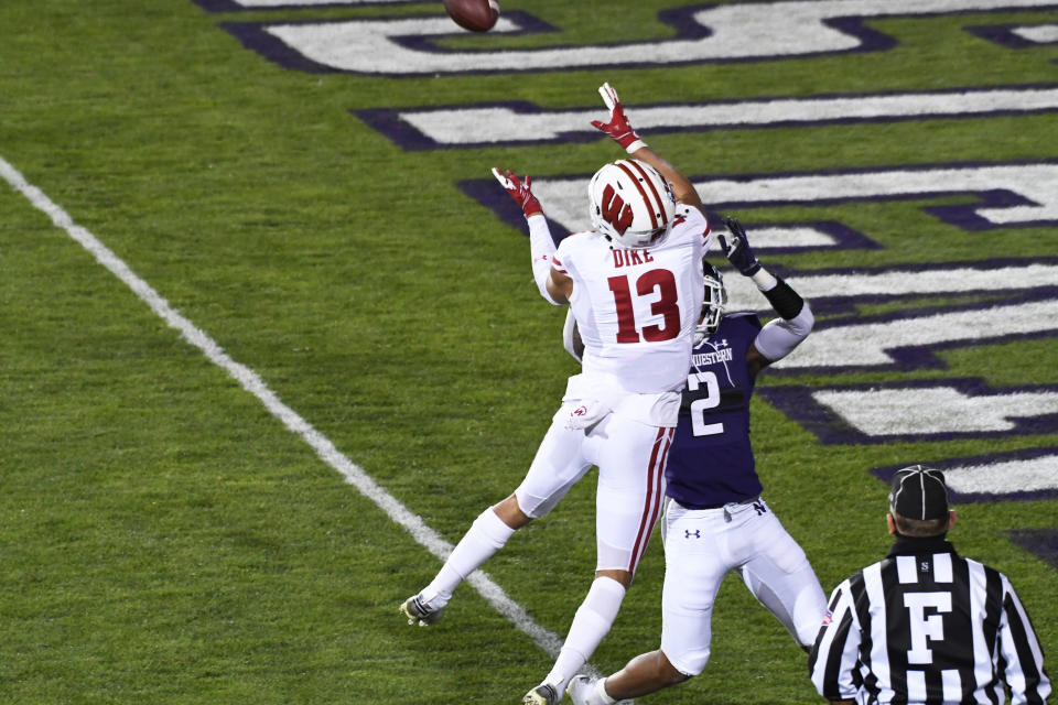 Nov 21, 2020; Evanston, Illinois, USA; Northwestern Wildcats defensive back Greg Newsome II (2) breaks up a pass to Wisconsin Badgers wide receiver Chimere Dike (13) during the second half at Ryan Field. Mandatory Credit: David Banks-USA TODAY Sports