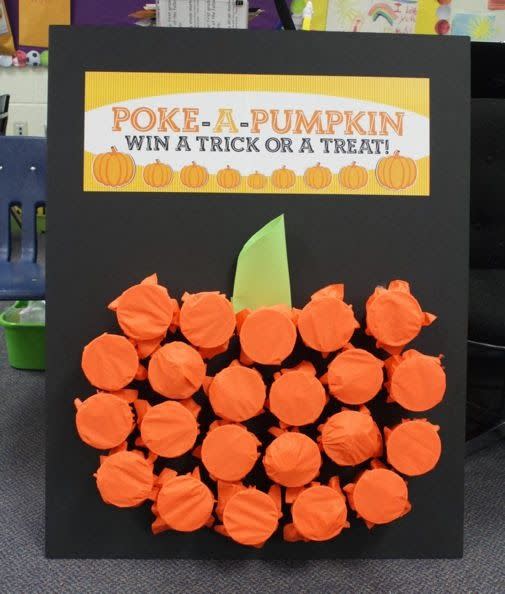 <p>Keep the kids entertained with this mystery prize game. Fill plastic cups with little trinkets, then cover with orange tissue paper and glue to poster board in the shape of a pumpkin. One by one, kids can poke a hole through the tissue paper and see what's inside. </p><p><em><a href="http://www.projectdenneler.com/2013/11/poke-pumpkin.html" rel="nofollow noopener" target="_blank" data-ylk="slk:Get the tutorial at Project Denneler »;elm:context_link;itc:0;sec:content-canvas" class="link ">Get the tutorial at Project Denneler »</a></em> </p>