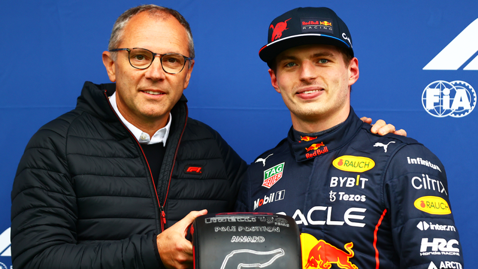 F1 boss Stefano Domenicali (pictured left) holding a tyre with F1 champion Max Verstappen. 