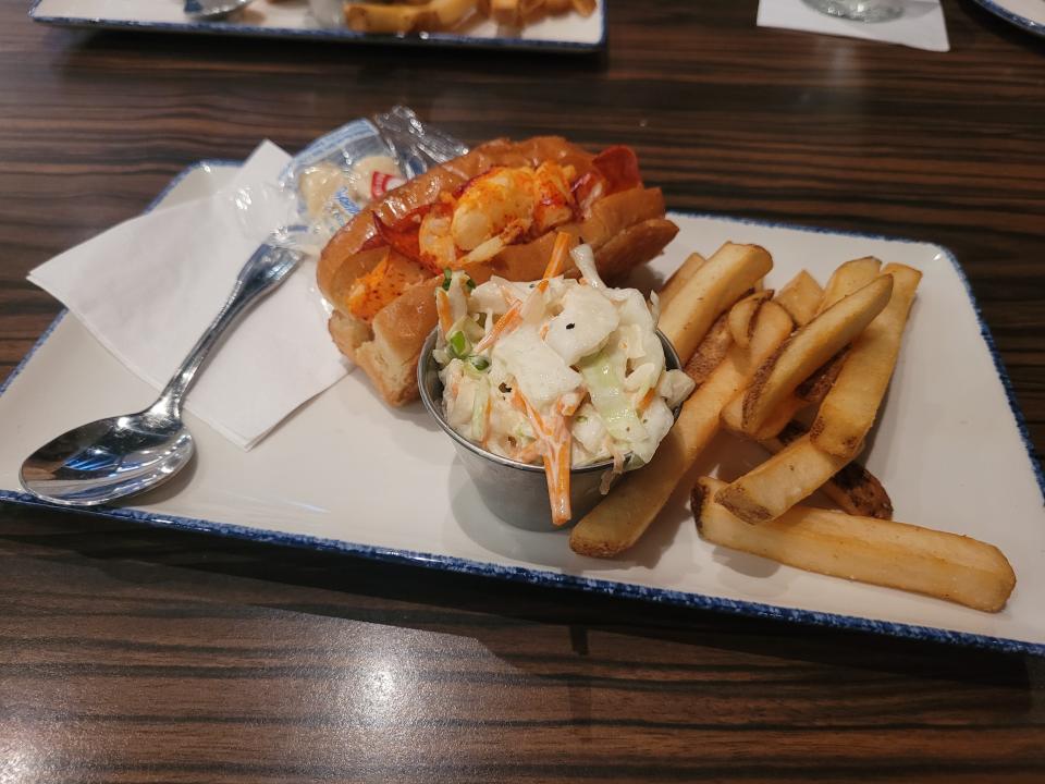 Lobster roll with coleslaw and steak fries at Legal Sea Foods