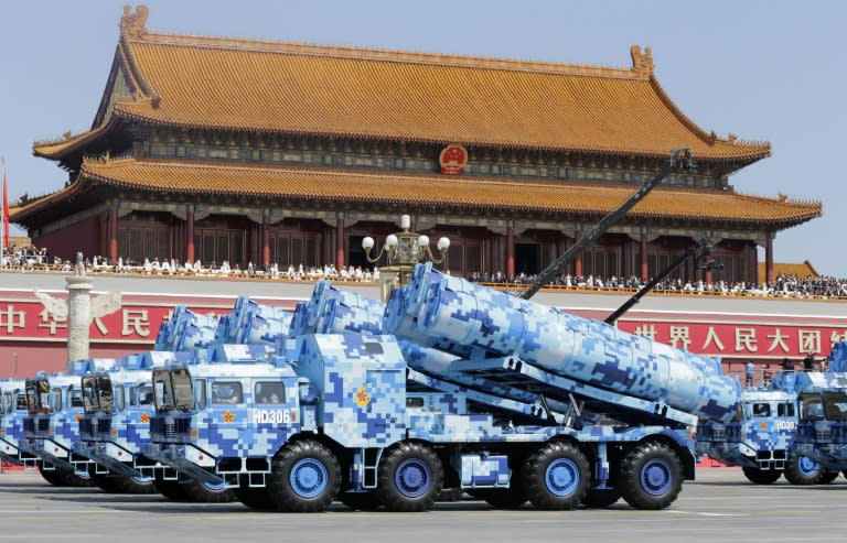 Military vehicles carrying shore-to-ship missiles drive past the Tiananmen Gate during a military parade in Beijing on September 3, 2015 to mark the 70th anniversary of victory over Japan and the end of World War II