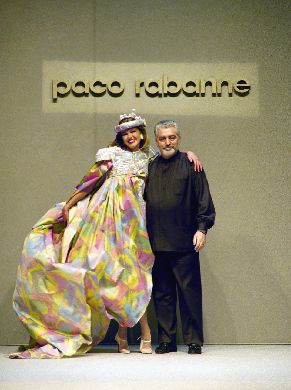 FILE - Franco-Spanish fashion designer Paco Rabanne poses with a model on January 30, 1991 in Paris, France. The Spanish-born pace-setting designer known for perfumes sold worldwide and his metallic, space-age fashions, has died, the group that owns his fashion house announced on its website Friday Feb.3, 2023. He was 88. (AP Photo/Pierre Gleizes, File)