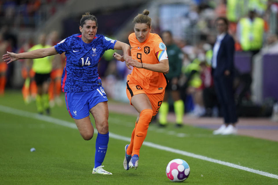 FILE - Netherlands' Vivianne Miedema runs with the ball pursued by France's Charlotte Bilbault, left, during the Women Euro 2022 quarterfinals soccer match between France and the Netherlands at the New York Stadium in Rotherham, England, Saturday, July 23, 2022. (AP Photo/Jon Super, File)