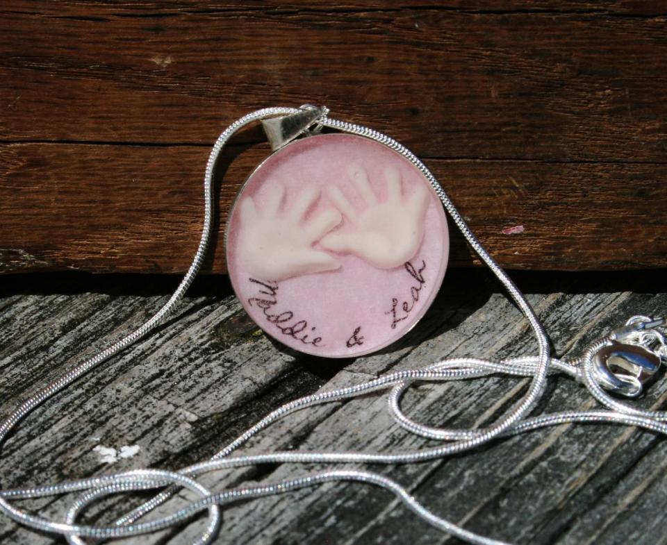 This product photo released by MommyMilk shows a necklace with a charm made of breast milk, one of the items jewelry designer Allicia Mogavero offers on the handmade marketplace site Etsy. Soap and other items make unusual keepsakes of a mother's special bond with her babies during nursing. (AP Photo/MommyMilk)