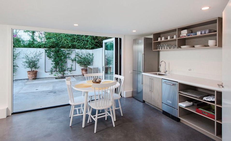 <p>The kitchen area in the guest-house features polished-cement flooring and industrial style cabinetry.</p>